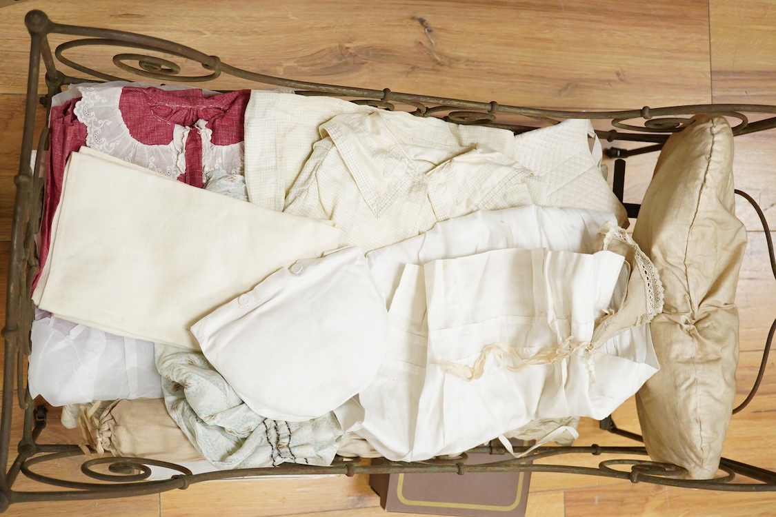 An Heubach Koppelsdorf bisque doll, mould 320 with sleeping eyes, open mouth and jointed composition body, together with a tubular and wrought metal half-tester bed, on casters, related clothing and bedding, doll 64cm